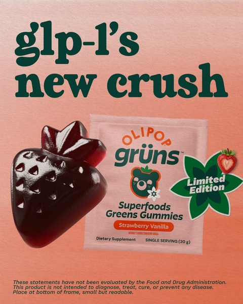 A minimalist, aesthetic-focused ad featuring a superfood gummy shaped like a strawberry, positioned as a trendy supplement choice.